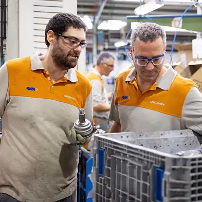 GKN Automotive workers holding parts.jpg
