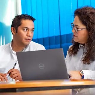 Two office workers by a laptop.jpg